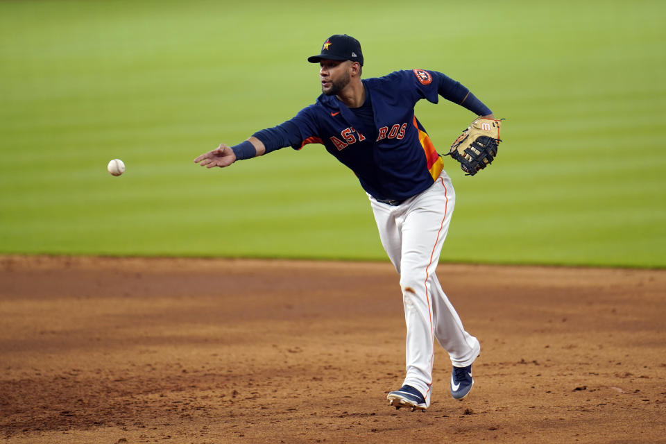 Houston Astros first baseman Yuli Gurriel tosses the ball during a simulated baseball game Thursday, July 9, 2020, in Houston. (AP Photo/David J. Phillip)