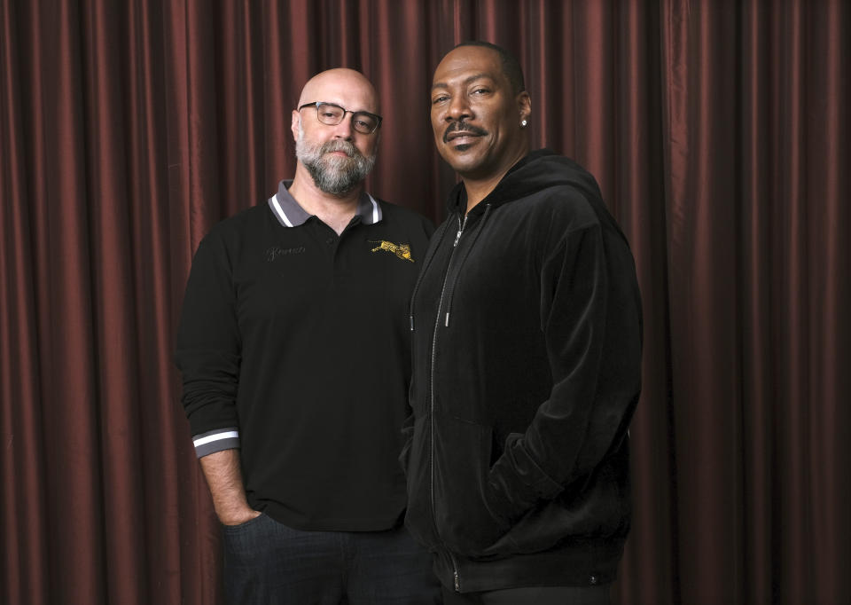 This Sept. 7, 2019 photo shows Eddie Murphy, right, star of the film "Dolemite Is My Name," with director Craig Brewer at the Shangri-La Hotel during the Toronto International Film Festival in Toronto. (Photo by Chris Pizzello/Invision/AP)