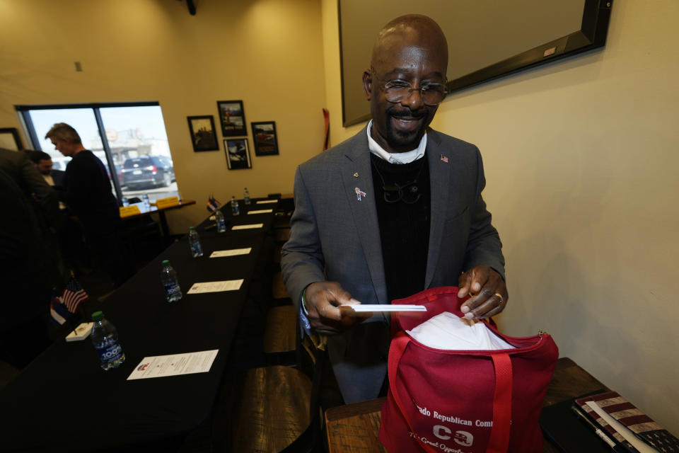 Candidate for the Colorado Republican Party chair position Casper Stockham sifts through his bag for campaign literature to hand out before a debate for the state Republican Party leadership position Saturday, Feb. 25, 2023, in in Hudson, Colo. (AP Photo/David Zalubowski)