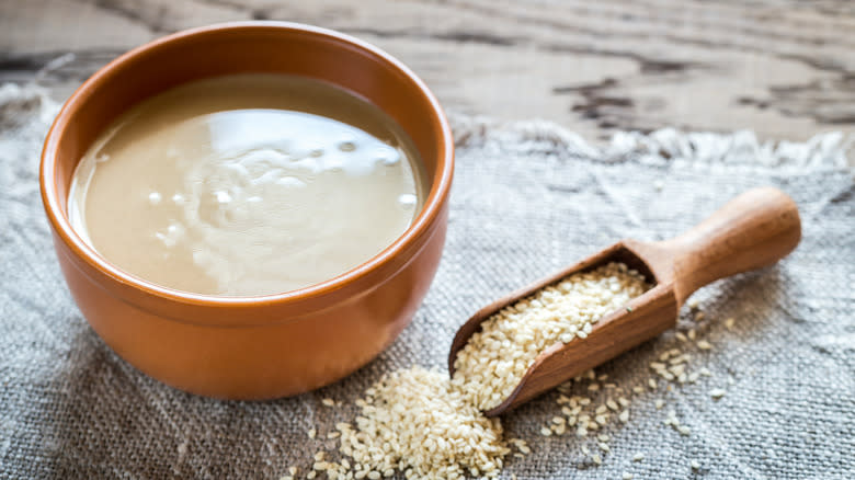 Wooden bowl of tahini with sesame seeds