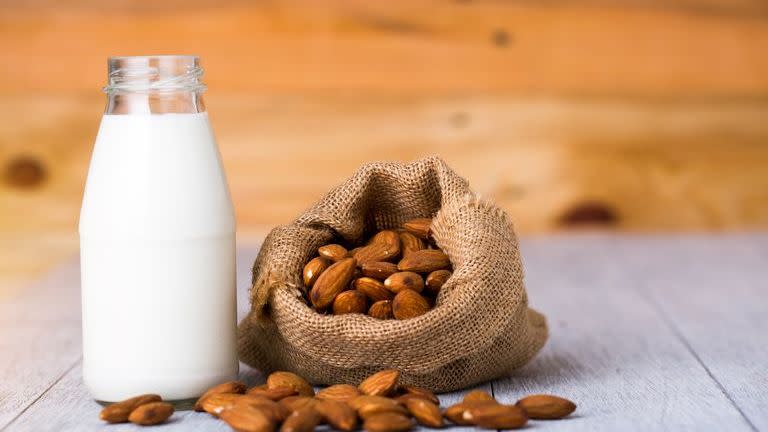 almonds and milk bottle on table
