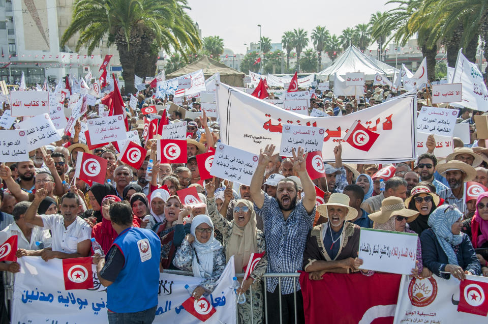 People demonstrate in Tunis, Saturday Aug 11, 2018. Thousands of Muslim fundamentalists have held an hours-long protest in front of the nation's parliament to decry proposals in a government report on gender equality. (AP Photo/Hassene Dridi)