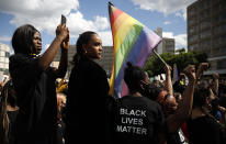 People gather at the Alexander Platz in Berlin, Germany, Saturday, June 6, 2020, to protest against the recent killing of George Floyd by police officers in Minneapolis, USA, that has led to protests in many countries and across the US. A US police officer has been charged with the death of George Floyd. (AP Photo/Markus Schreiber)