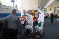 Members of the medical team wear protective face masks, following the coronavirus outbreak, as they prepare disinfectant liquid to sanitise public places in Tehran