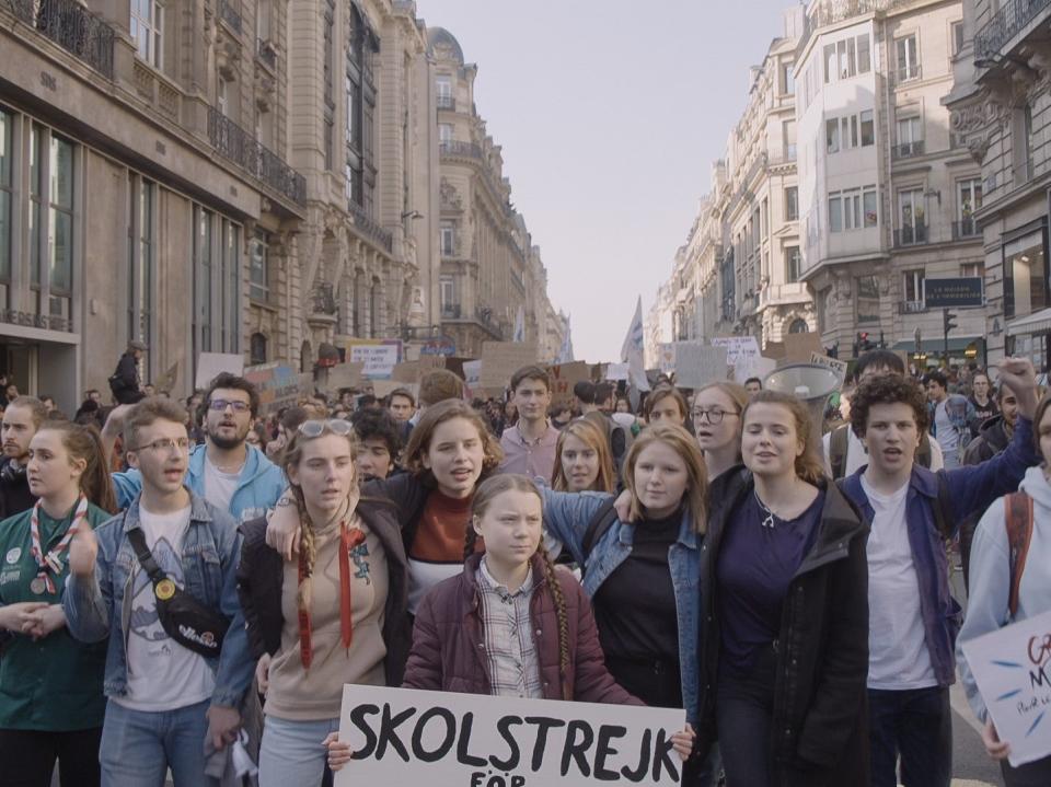 Thunberg marches with a crowd demanding action on the global climate crisisDogWoof