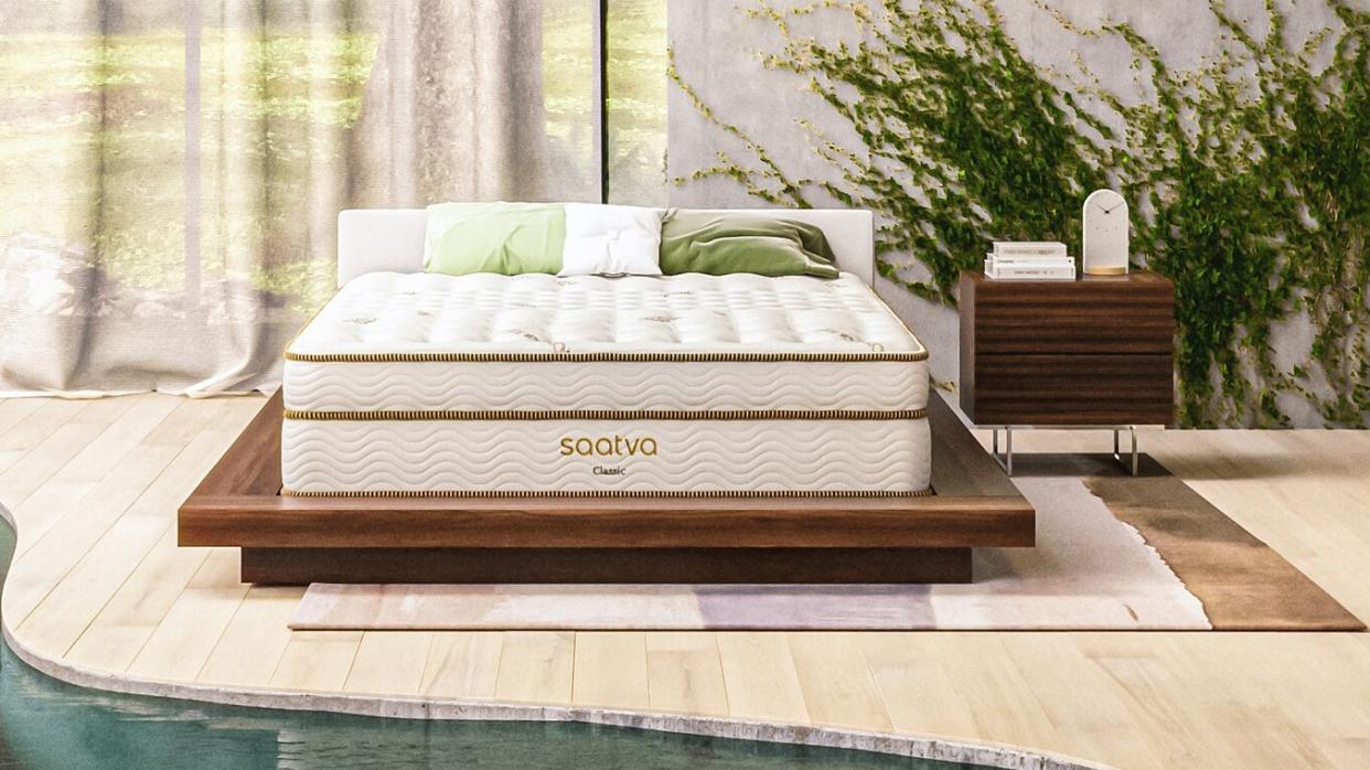  The Saatva Classic mattress photographed in a stylish white pool room with an indoor river. 