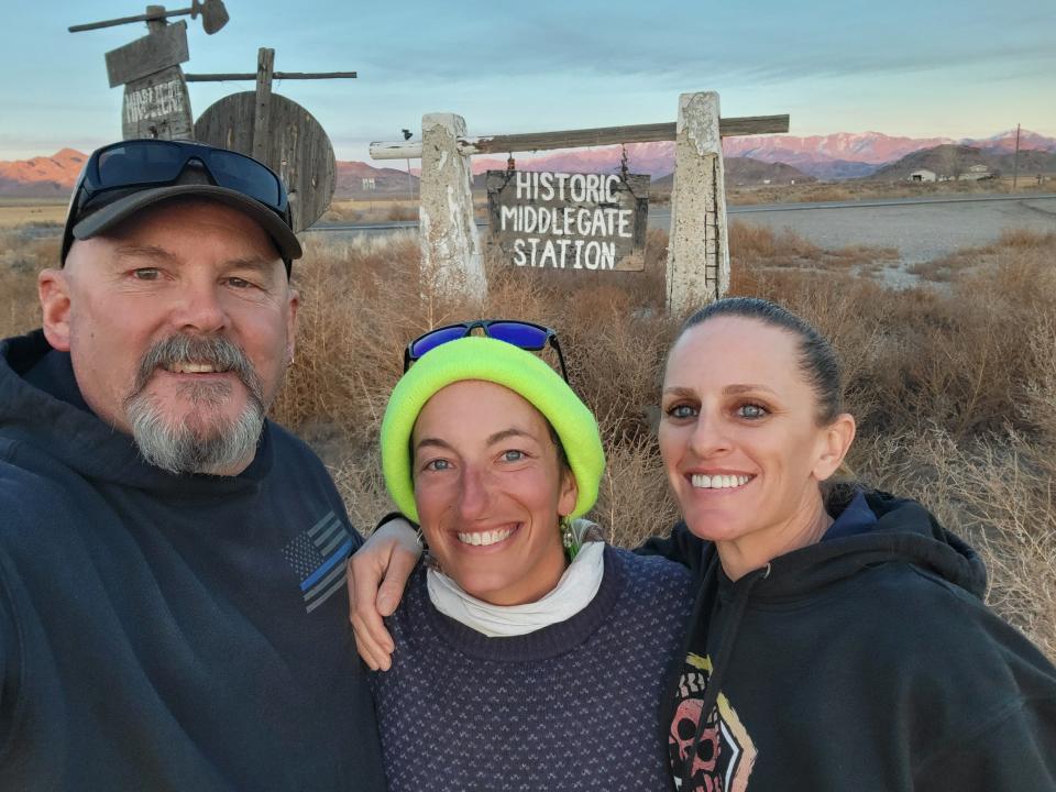 Briana DeSanctis, middle, poses with Duane and Andrea Carnahan, a couple she met and befriended while hiking through Nevada. The Carnahans, who are already legally married, have invited DeSanctis to their August wedding ceremony.