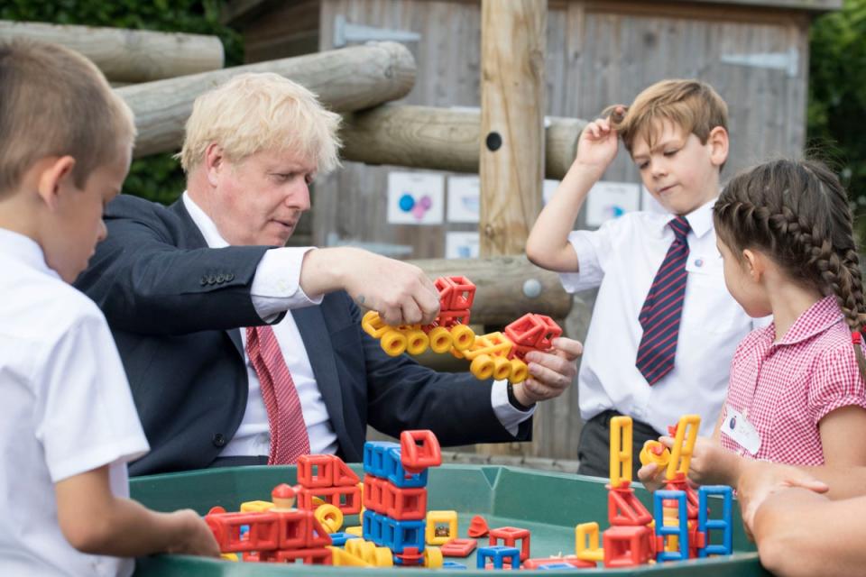 Prime Minister Boris Johnson joining children playing with construction toys during a visit to The Discovery School in West Malling, Kent. (PA)