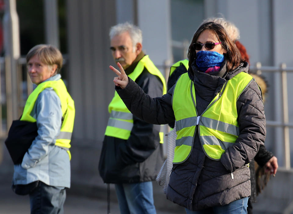 Demonstrators wearing yellow vests protest at the toll gates of a motorway, in Biarritz, southwestern France, Monday, Dec. 10, 2018. French President Emmanuel Macron will be speaking to his nation at last Monday, after increasingly violent, radicalized protests against his leadership have shaken the country and scarred its beloved capital. His long silence has aggravated that anger and many protesters are hoping only to hear one thing from Macron: “I quit.” (AP Photo/Bob Edme)