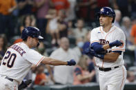 Houston Astros' Chas McCormick (20) reaches to fist-bump Robel Garcia, right, after Garcia's home run during the sixth inning of the team's baseball game against the Minnesota Twins on Thursday, Aug. 5, 2021, in Houston. (AP Photo/Michael Wyke)