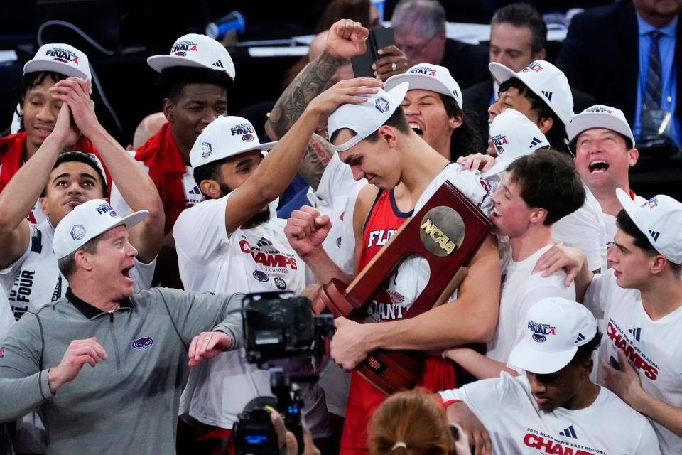 Mar 25, 2023; New York, NY, USA; Florida Atlantic Owls center Vladislav Goldin, center, reacts as he holds the East Regional Champion trophy following their 79-76 victory against the Kansas State Wildcats in an NCAA tournament East Regional final at Madison Square Garden. Mandatory Credit: Robert Deutsch-USA TODAY Sports