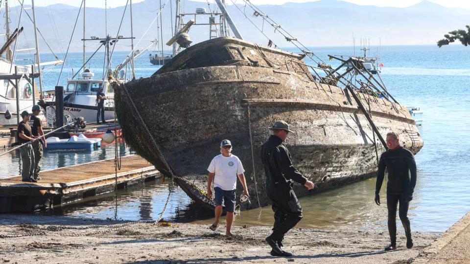 Two pieces of heavy machinery were needed to haul the sunken Lady Maxine out of Morro Bay on Thursday, Nov. 11, 2021, after the derelict fishing boat was raised from the harbor floor. The boar sank in July.