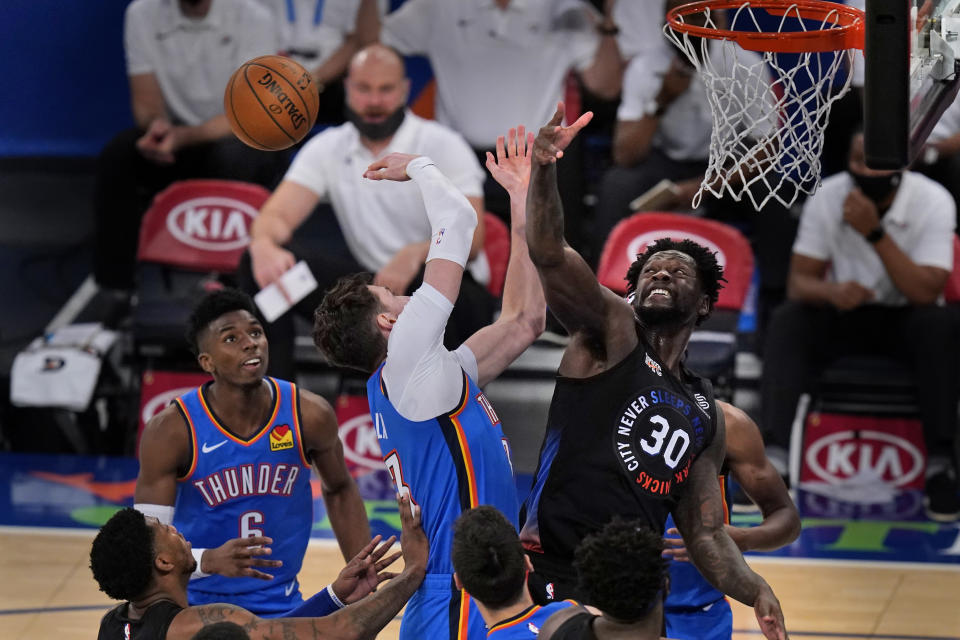 New York Knicks' Julius Randle, right, fights for a rebound during the second half of an NBA basketball game against the Oklahoma City Thunder, Friday, Jan. 8, 2021, in New York. (AP Photo/Seth Wenig, Pool)
