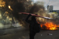 <p>A student brings wood to a fire started by student protesters during the first day of a strike against government cutbacks in education, Complutense University, Madrid, March 26, 2014. (AP Photo/Andres Kudacki) </p>