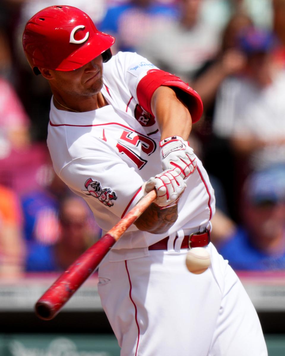 Cincinnati Reds center fielder Nick Senzel (15) hits a double in the first inning of a baseball game between the New York Mets and the Cincinnati Reds, Thursday, May 11, 2023, in Cincinnati.