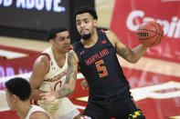 Maryland guard Eric Ayala (5) handles the ball in front of Wisconsin guard D'Mitrik Trice (0) during the first half of an NCAA college basketball game Wednesday, Jan. 27, 2021, in College Park, Md. (AP Photo/Nick Wass)