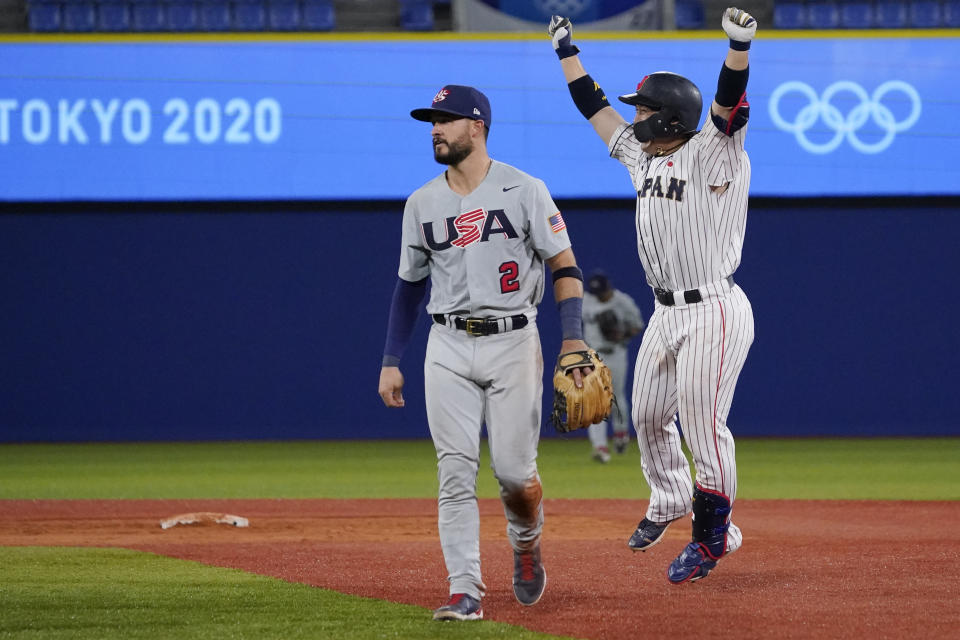 Japan's Takuya Kai, right, celebrate past United States' Eddy Alvarez after a baseball game at the 2020 Summer Olympics, Monday, Aug. 2, 2021, in Yokohama, Japan. Japan won 7-6. (AP Photo/Sue Ogrocki)