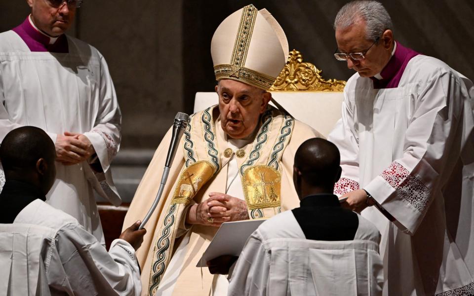 Attendants with the Pope as he prepares for his duties