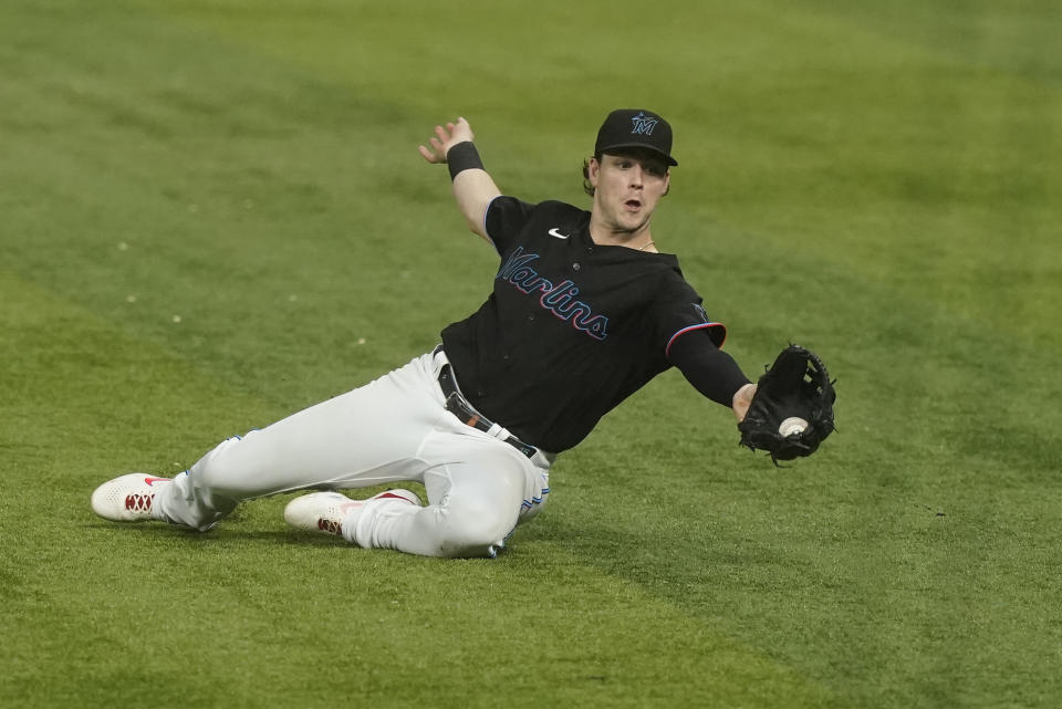 Miami Marlins third baseman Brian Anderson (15) catches a hit by Washington Nationals' Riley Adams (15) during the ninth inning of a baseball game, Friday, Sept. 23, 2022, in Miami. The Marlins defeated the Nationals 5-2. (AP Photo/Marta Lavandier)