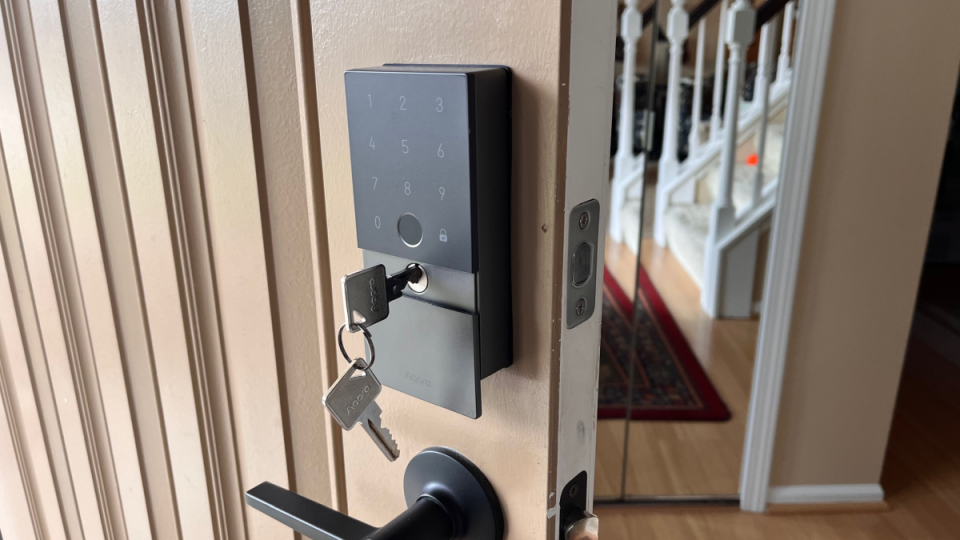 The Aqara Smart Lock U100 shown with its mechanical key.