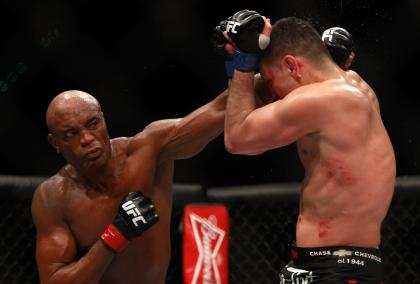 Anderson Silva punches Nick Diaz at UFC 183 on Saturday. (Getty)