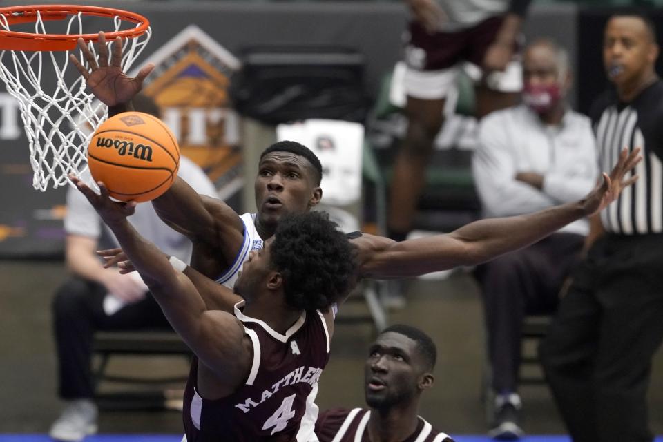 Mississippi State guard Cameron Matthews (4) goes up for a shot as Memphis center Moussa Cisse, rear, defends in the second half of an NCAA college basketball championship game in the NIT, Sunday, March 28, 2021, in Frisco, Texas. (AP Photo/Tony Gutierrez)