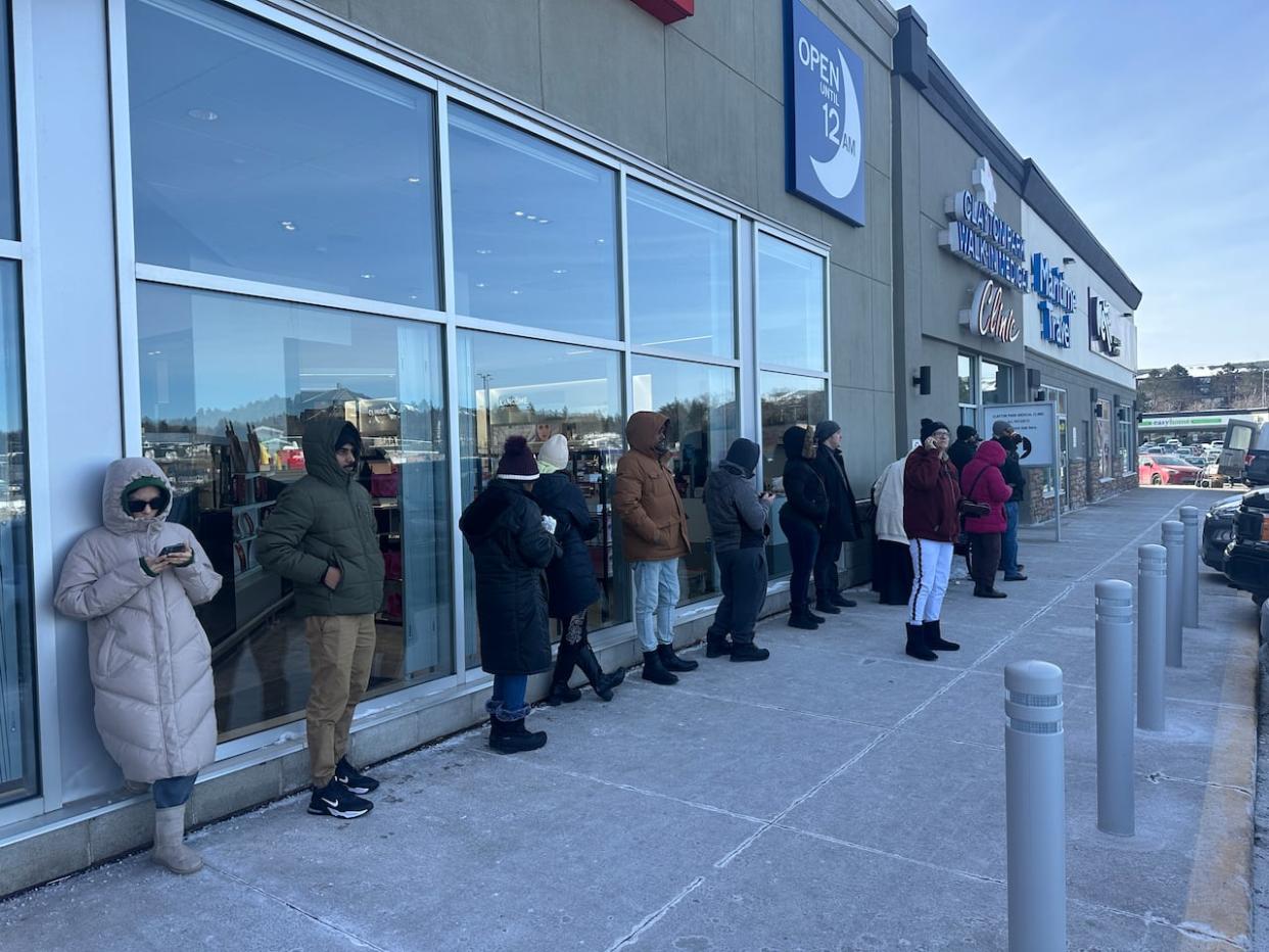 People waiting outside the Clayton Park Medical Clinic on Wednesday expected it would take two hours to get inside.  (Luke Ettinger/CBC - image credit)