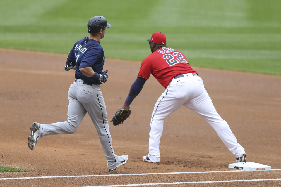 Minnesota Twins' Miguel Sano (22) forces out Seattle Mariners' Mitch Haniger (17) at first after fielding the ball from Twins' Andrelton Simmons (9) during the first inning of a baseball game, Saturday, April 10, 2021, in Minneapolis. (AP Photo/Stacy Bengs)