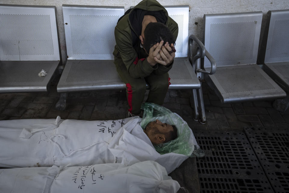 Palestinians mourn their relatives killed in the Israeli bombardment of the Gaza Strip, at the hospital Rafah, southern Gaza, Thursday, Dec. 14, 2023. (AP Photo/Fatima Shbair)