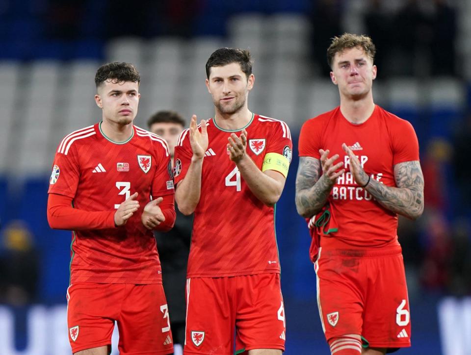 Wales captain Ben Davies applauds fans alongside his teammates (PA)