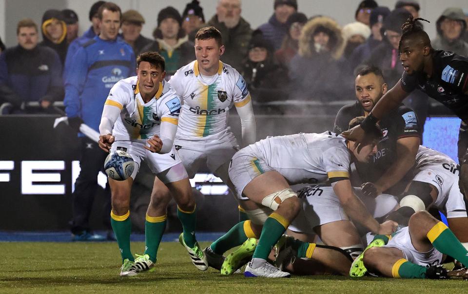 Alex Mitchell gets the ball away under pressure from Saracens