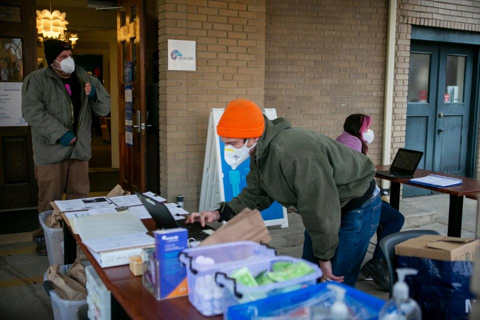 Billy Golden and Rob Goeller, who specialize in harm reduction and used to work at Caracole, in Northside, prepare for the organization's drive up exchange program.