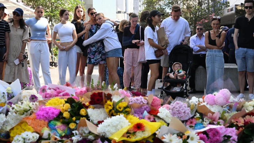 Crowds gather by floral tributes to victims of the Bondi mall stabbings