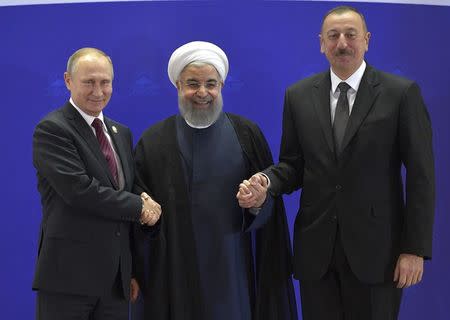 (L-R) Russia's President Vladimir Putin, Iran's President Hassan Rouhani and Azerbaijan's President Ilham Aliyev shake hands while posing for a picture during a meeting in Tehran, Iran November 1, 2017. Sputnik/Alexei Druzhinin/Kremlin via REUTERS