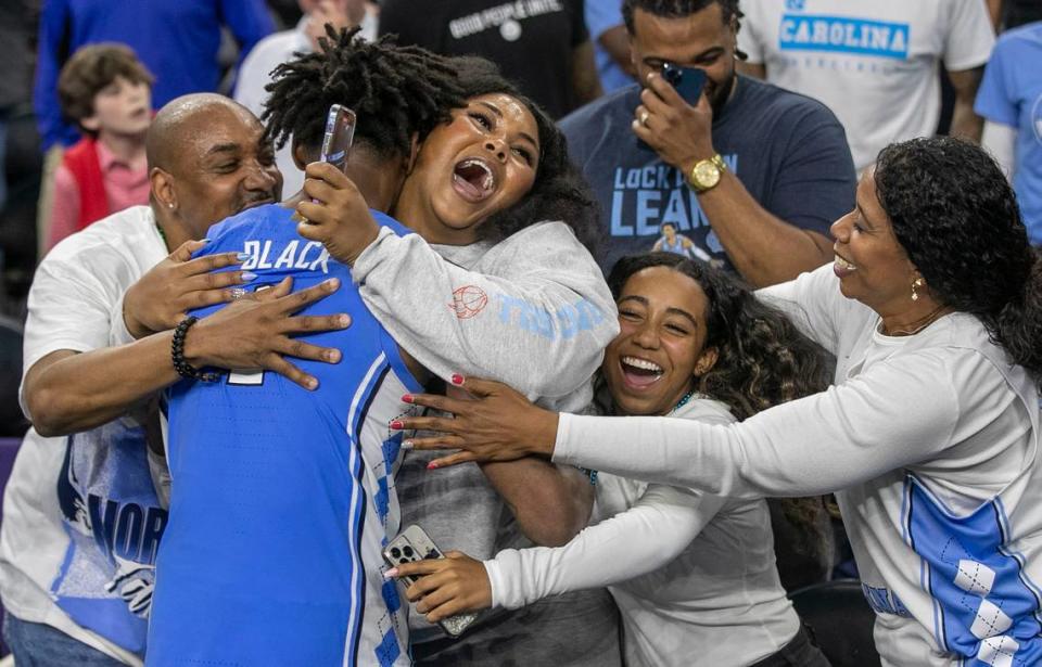 North Carolina’s Leaky Black (1) is embraces by his family following the Tar Heels’ 81-77 victory over Duke during the NCAA Final Four semi-final on Saturday, April 2, 2022 at Caesars Superdome in New Orleans, La.