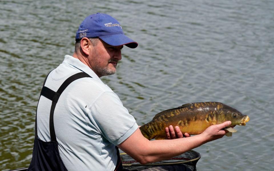 People enjoying one of the UK's favourite past-times at Makins Fishery, Warwickshire, Britain, 18 May 2020 - SHUTTERSTOCK