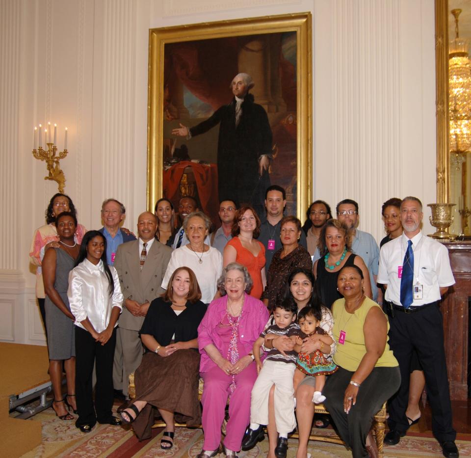 Descendants of Paul Jennings, an enslaved butler and valet who helped save the iconic painting of George Washington from the British as they prepared to burn the White House in the War of 1812, gather in front of the portrait at a 2009 White House ceremony.