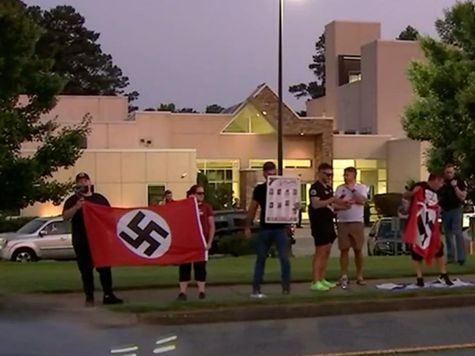 Shocking pictures and videos showed neo-Nazis with swastikas outside the Chabad of Cobb synagogue on Friday (WMAZ)