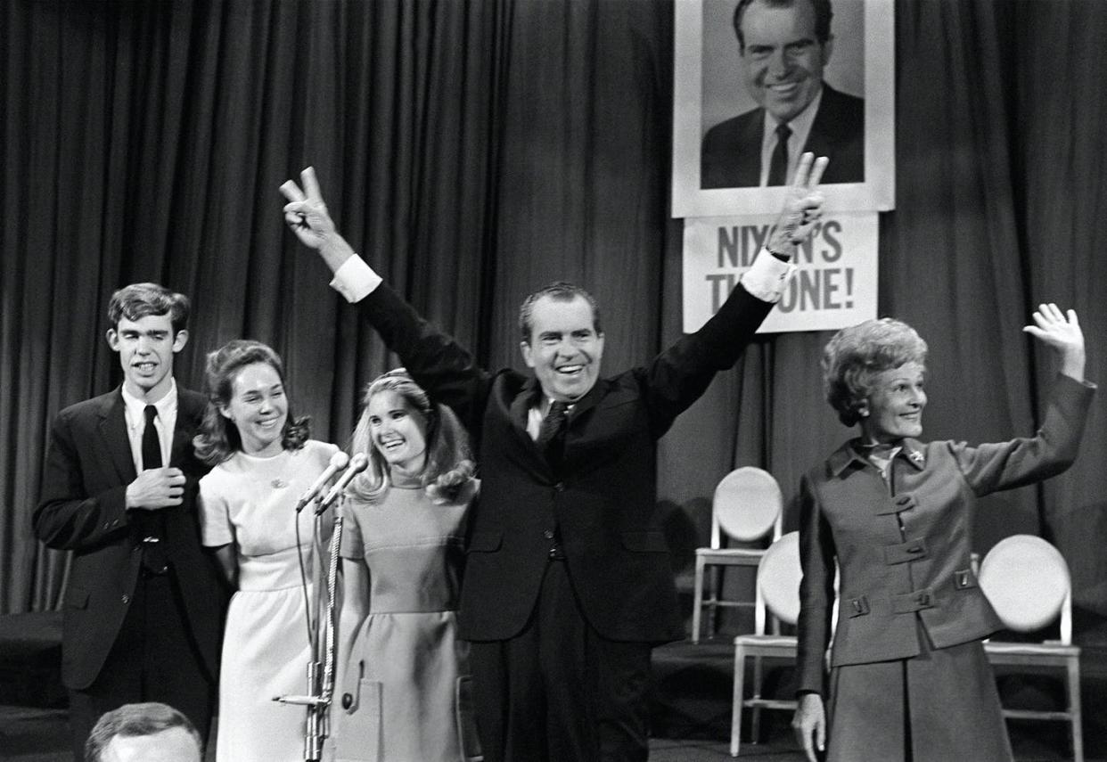 <span class="caption">Richard Nixon, celebrating his election on Nov. 7, 1968, campaigned against a backdrop of racial inequality, civic unrest and polarized politics.</span> <span class="attribution"><a class="link " href="https://www.gettyimages.com/detail/news-photo/republican-presidential-candidate-richard-nixon-is-news-photo/1157399033?adppopup=true" rel="nofollow noopener" target="_blank" data-ylk="slk:AFP via Getty Images;elm:context_link;itc:0;sec:content-canvas">AFP via Getty Images</a></span>