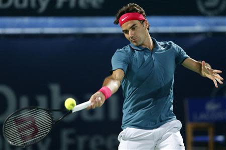 Roger Federer of Switzerland returns the ball to Tomas Berdych of the Czech Republic during their men's singles final match at the ATP Dubai Tennis Championships, March 1, 2014. REUTERS/Saleh Salem