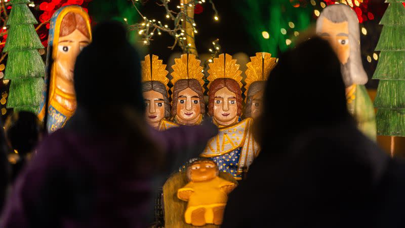 Visitors look at a nativity scene and the Christmas lights at Temple Square in Salt Lake City on Sunday, Nov. 26, 2023.