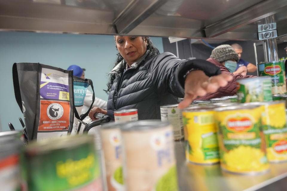 Betsy Quiroa shops at a market-style food pantry at the Carver Center in Port Chester, N.Y., Wednesday, Nov. 15, 2023. A growing number of states are working to keep food out of landfills over concerns that it is taking up too much space and posing environmental problems. Some states including New York are requiring supermarkets and other businesses to redirect food to food pantries. (AP Photo/Seth Wenig)