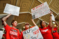 <p>Teachers and supporters hold signs during a ‘March For Students And Rally For Respect’ protest at the North Carolina State Assembly, on the first day of the state’s legislative session, in Raleigh, N.C., on Wednesday, May 16, 2018. At least 29 North Carolina public school districts serving 865,000 students will close their doors asÂ teachers walk out in the fifth large-scale demonstration in less than three months in states with Republican-led legislatures, most of them organized on the internet in places where unions are weak. (Photo: Charles Mostoller/Bloomberg via Getty Images) </p>