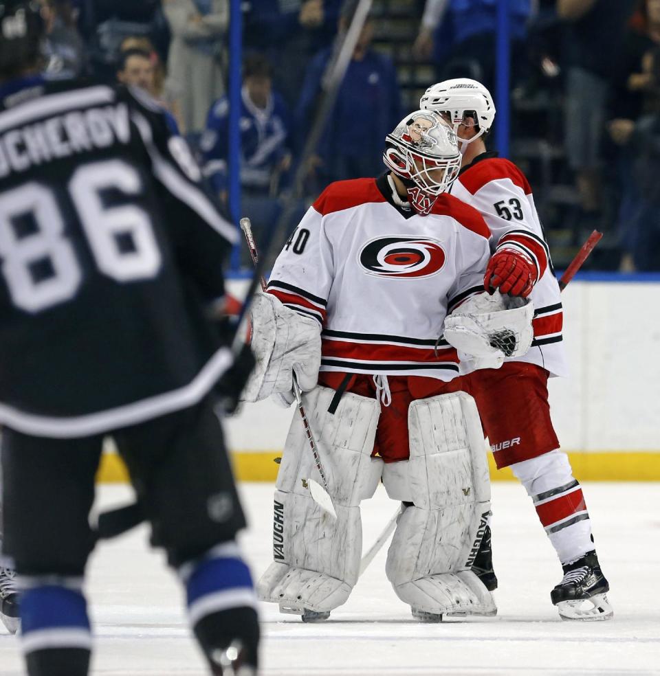 Carolina Hurricanes emergency backup goalie Jorge Alves is given the game puck by Jeff Skinner (53) following his NHL debut in the team's NHL hockey game against the Tampa Bay Lightning oni Saturday, Dec. 31, 2016, in Tampa, Fla. (AP Photo/Mike Carlson)