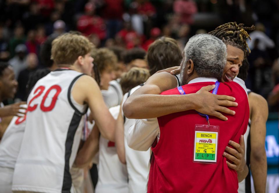 Orchard Lake St. Mary's Trey McKenney hugs his coach after defeating North Farmington 63-52 during the MHSAA Div. 1 state finals at the Breslin Center in East Lansing on Saturday, March 16, 2024.