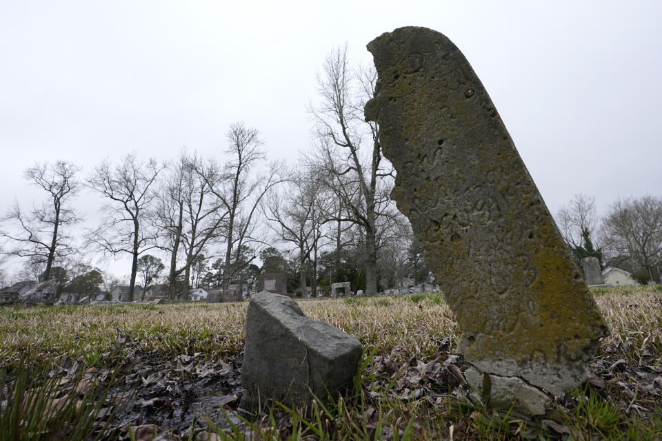 A deteriorating tombstone is close to collapse at the Lincoln Memorial Cemetery in Portsmouth, Va., Tuesday, March 23, 2021. Many Black Americans excluded from white-owned cemeteries built their own burial spaces, and their descendants are working to preserve the grounds. Racism still haunts these cemeteries, though. Many are at risk of being lost and lack the support other cemeteries have received. (AP Photo/Steve Helber)