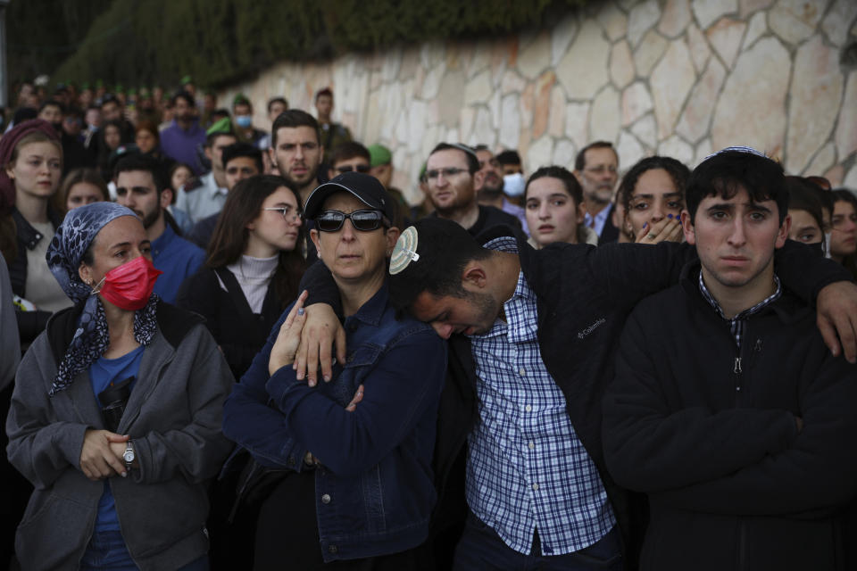 Mourners grieve at the funeral for Eliyahu Kay, a 26-year-old immigrant to Israel from South Africa, the day after he was killed when a Palestinian man opened fire in the Old City of Jerusalem, Monday, Nov. 22, 2021, in Jerusalem. (AP Photo/Oded Balilty)