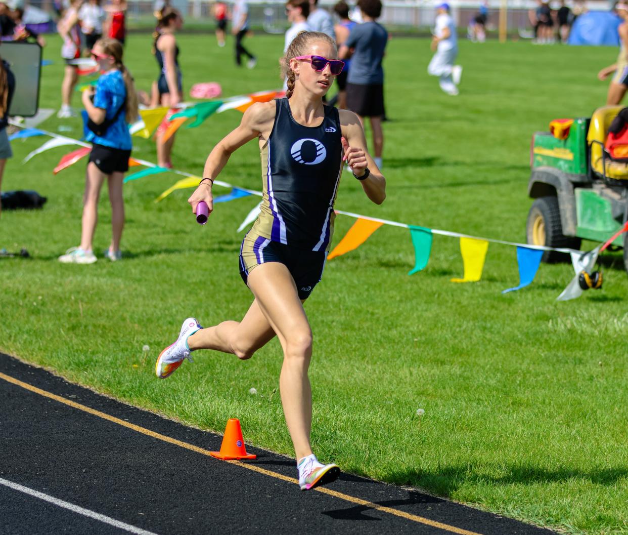 Onsted's Emmry Ross runs her leg of the 4x800 during the Onsted Boosters Invite.