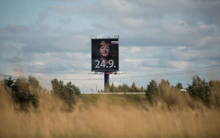 An election campaign poster for the upcoming general elections of the Christian Democratic Union party (CDU) with a headshot of German Chancellor Angela Merkel is displayed in Wustermark near Berlin, Germany, September 20, 2017. REUTERS/Stefanie Loos