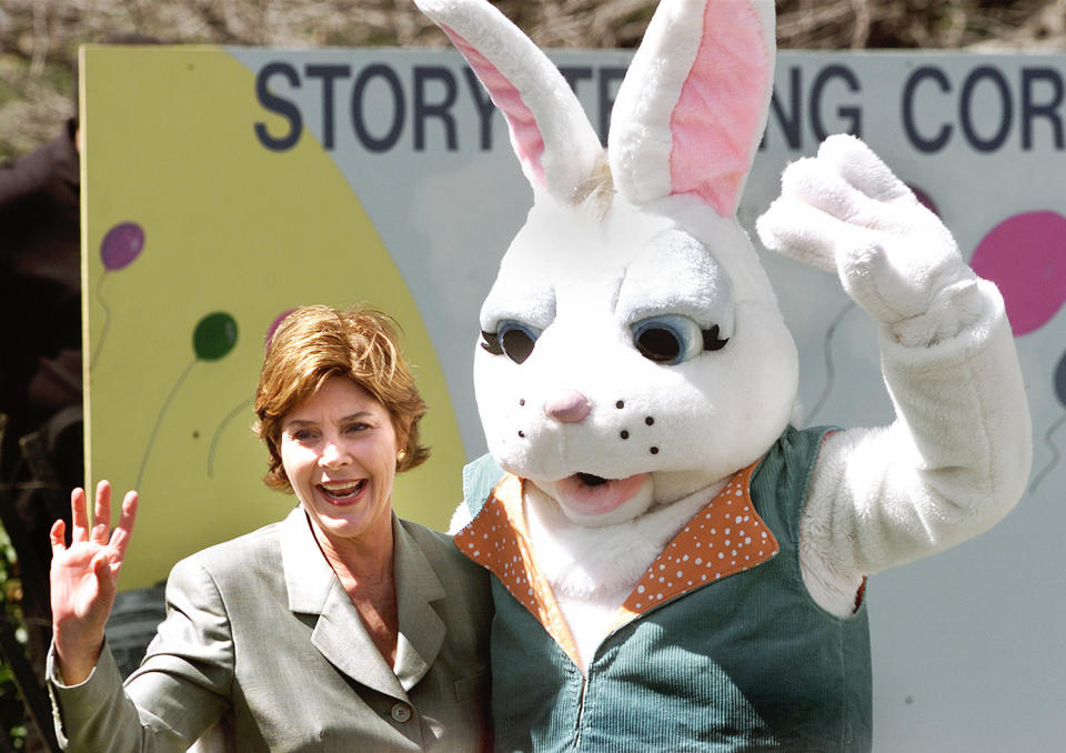 <p>First lady Laura Bush waves with the Easter Bunny at the annual White House Easter Egg Roll, Monday, April 1, 2002, in Washington. 10,800 eggs were boiled, the president’s dog was captured in a chocolate sculpture and the White House opened the gates to hundreds of children for the annual egg roll on the South Lawn. (Photo: Ron Edmonds/AP) </p>